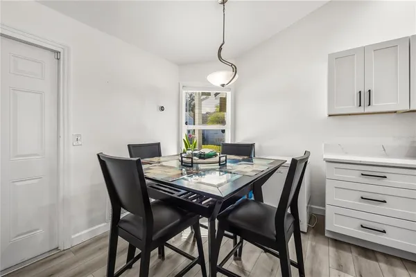a view of a dining room a table and chairs