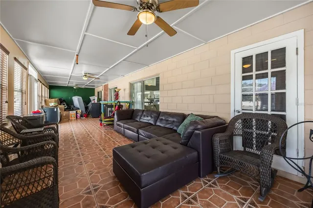 a view of a hallway with wooden floor and a potted plant