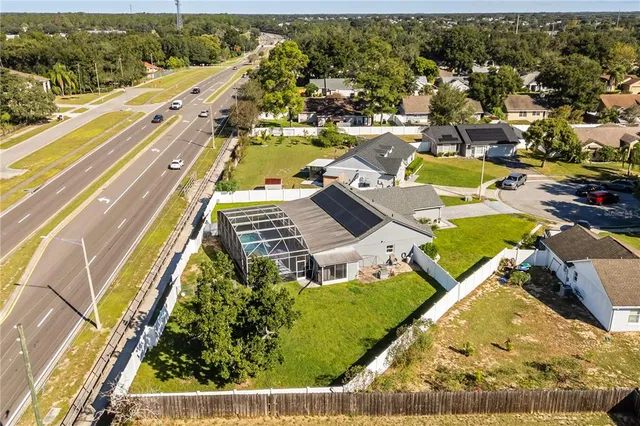 an aerial view of residential houses with outdoor space