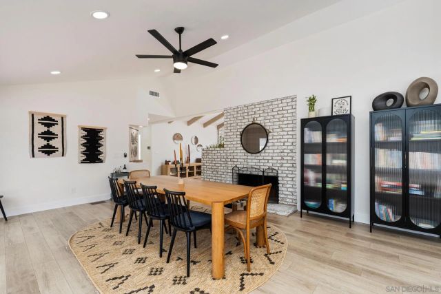 a living room with furniture large wooden floor and large window