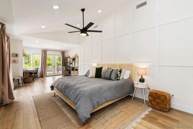 a living room with furniture pool table and a potted plant