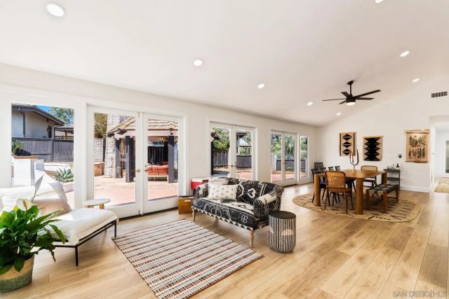 a dining room with furniture window and wooden floor