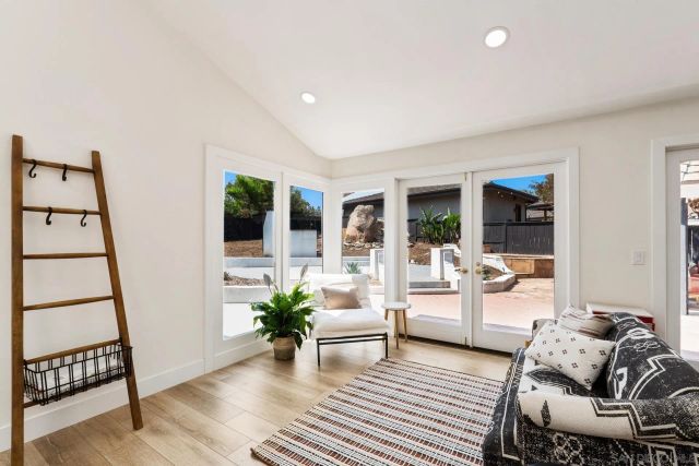 a dining room with furniture and a floor to ceiling window