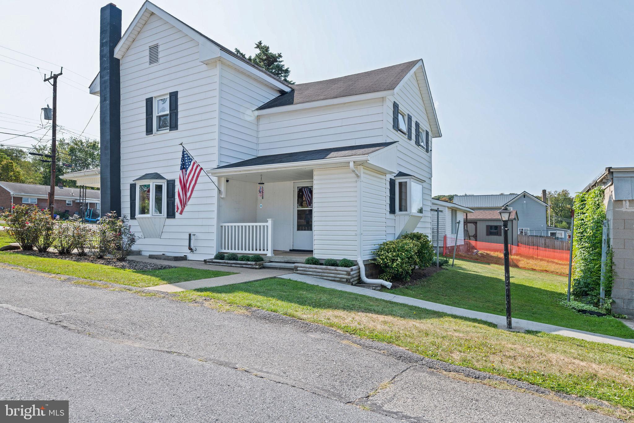 113 Loch Lomond Road Philipsburg, PA 16866 - Photo 2 of 33 a front view of a house with a yard and garage