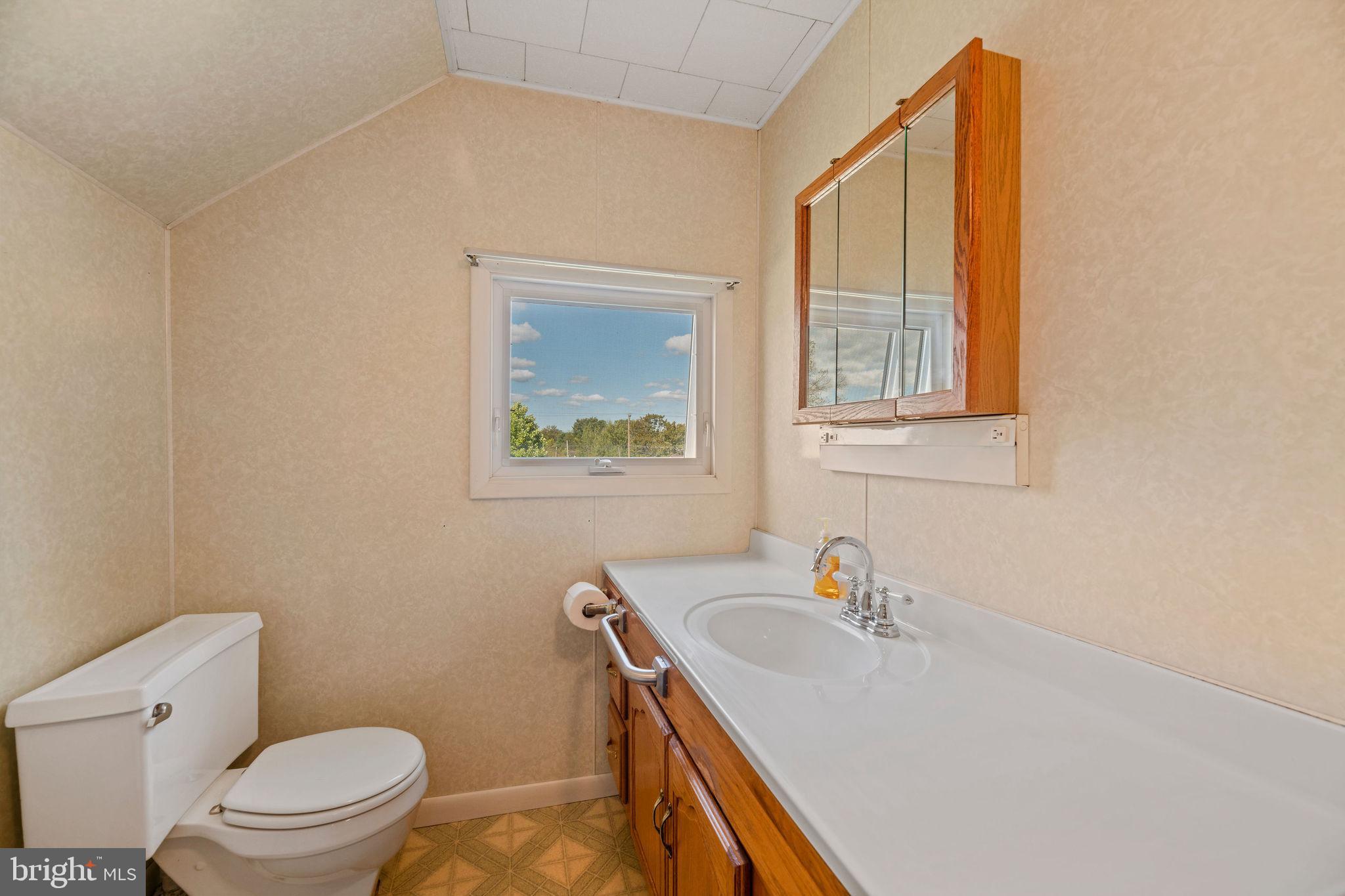 113 Loch Lomond Road Philipsburg, PA 16866 - Photo 28 of 33 a bathroom with a sink a toilet and a window