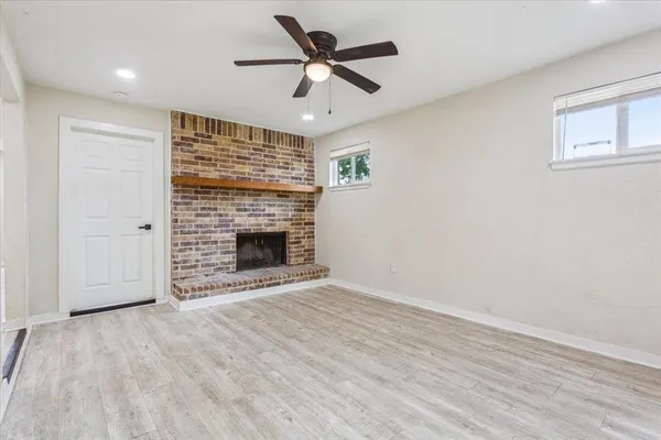wooden floor in an empty room with a fireplace