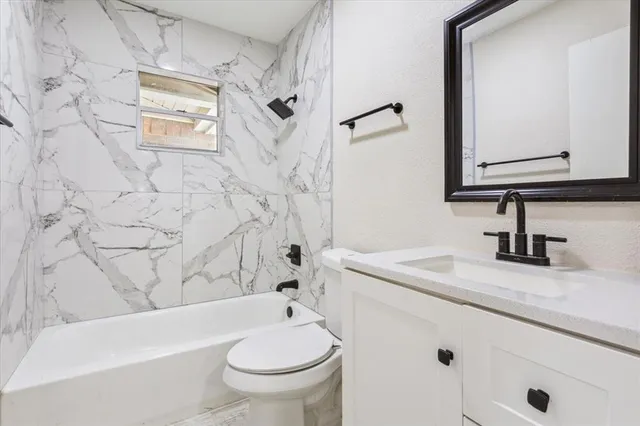 a bathroom with a sink a toilet and a bathtub