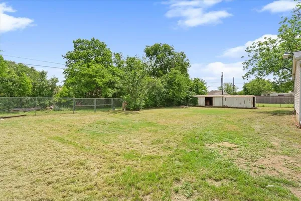 a view of a yard with a house in the background