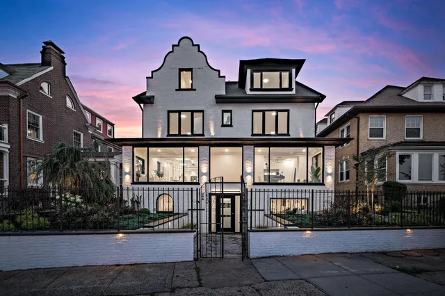 a front view of a residential apartment building with a yard