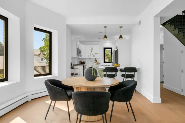 a dining room with furniture and wooden floor