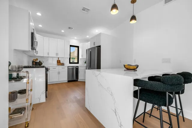 a kitchen with a refrigerator a sink and dishwasher
