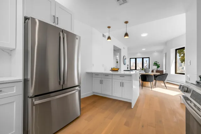 a kitchen with stainless steel appliances granite countertop a stove and a microwave