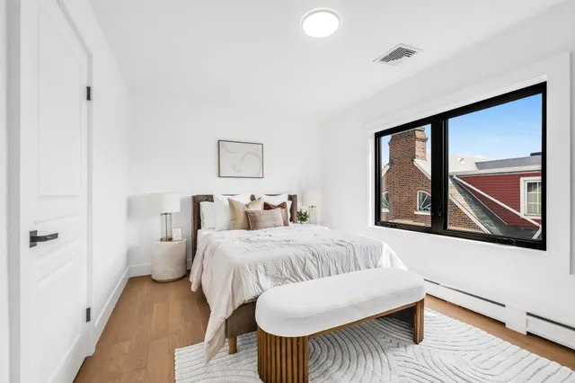 a bedroom with a bed and a potted plant