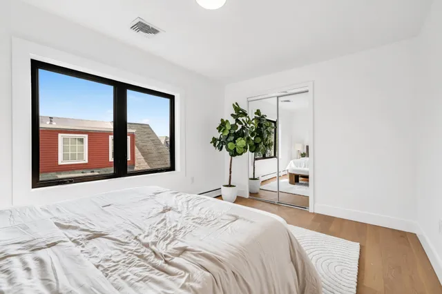 a bedroom with a bed and a mirror