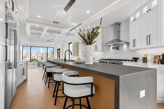 a kitchen with stainless steel appliances granite countertop a sink a stove and a refrigerator