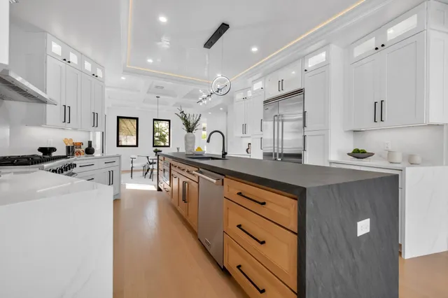 a kitchen with stainless steel appliances granite countertop a lot of counter space and windows