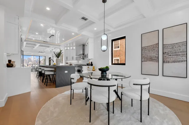a view of a dining room with furniture and chandelier