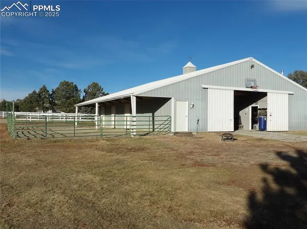a view of a house with backyard and trees