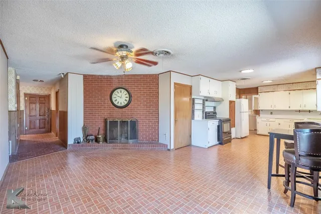 a view of a kitchen with a stove cabinets and wooden floor
