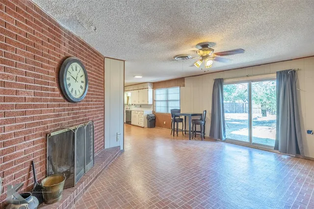 a view of livingroom with furniture fan and a fireplace