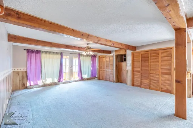 a view of an empty room with windows