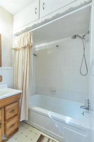 a bathroom with a shower and a bath tub