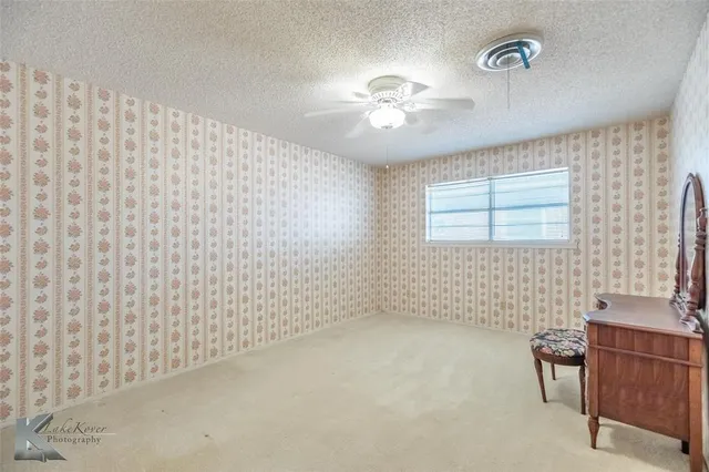 a bathroom with a granite countertop sink a mirror and a shower