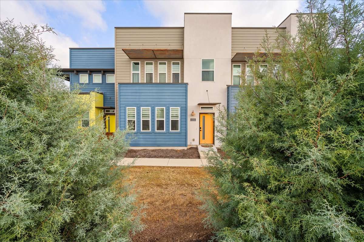 9015 Cattle Baron Path, Unit 1203 Austin, TX 78747 - Photo 1 of 23 Rear view of house with stucco siding
