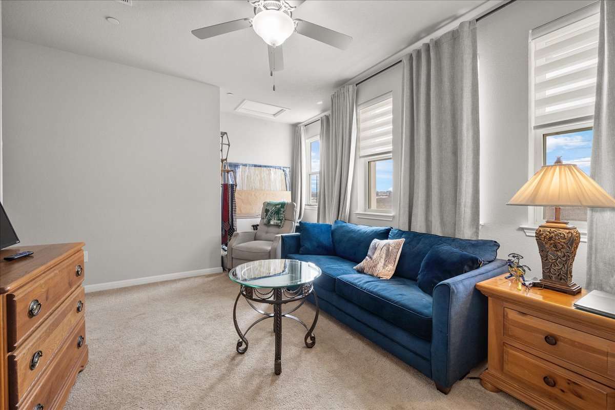 9015 Cattle Baron Path, Unit 1203 Austin, TX 78747 - Photo 19 of 23 Living room featuring light colored carpet and a ceiling fan