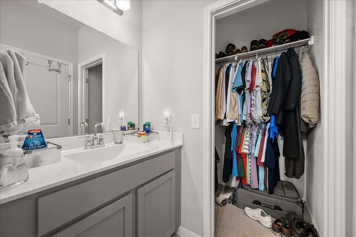 9015 Cattle Baron Path, Unit 1203 Austin, TX 78747 - Photo 21 of 23 Bathroom with vanity and baseboards