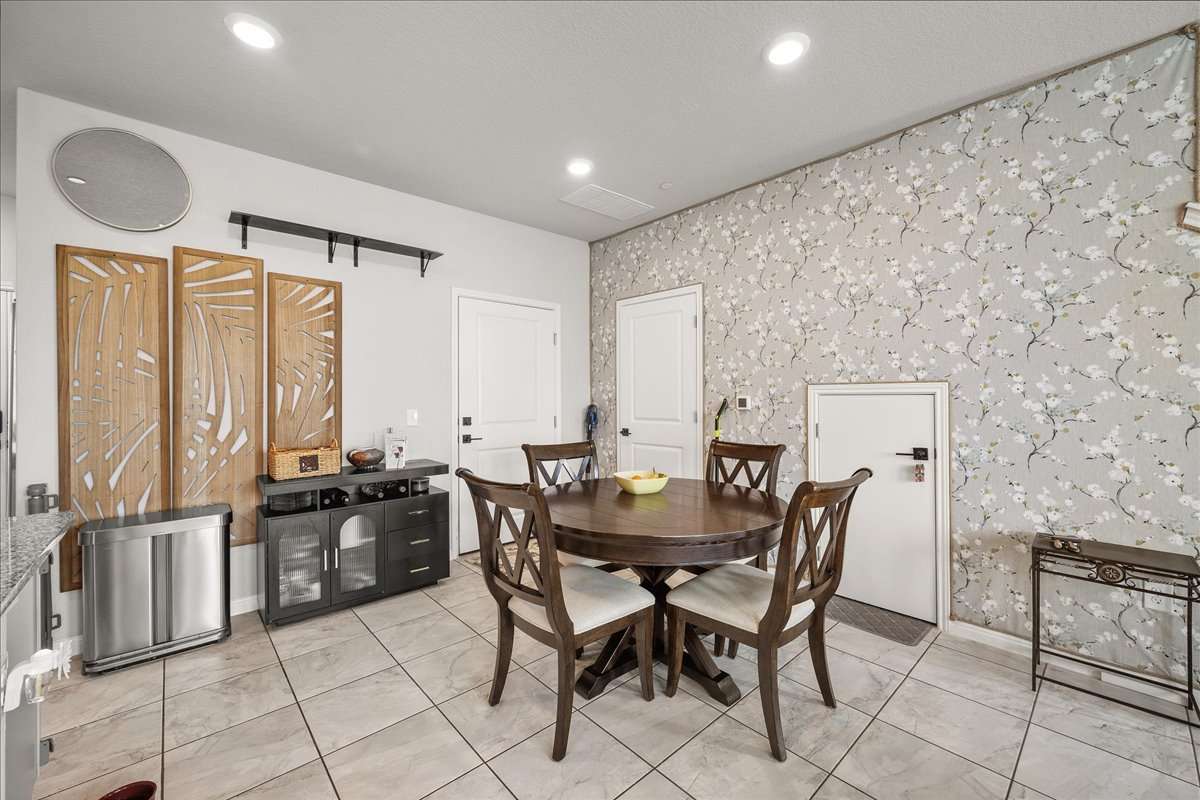 9015 Cattle Baron Path, Unit 1203 Austin, TX 78747 - Photo 6 of 23 Dining space with wallpapered walls and recessed lighting