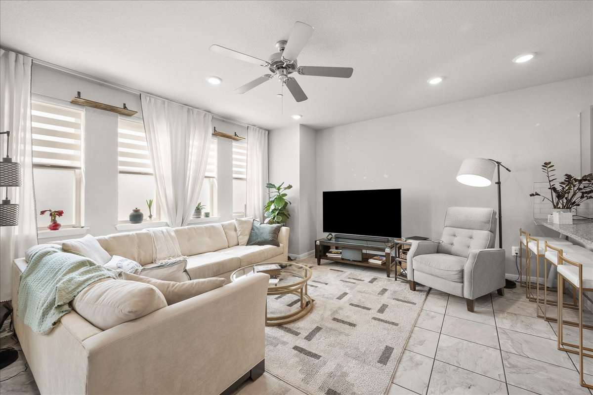 9015 Cattle Baron Path, Unit 1203 Austin, TX 78747 - Photo 8 of 23 Living area with a ceiling fan and recessed lighting