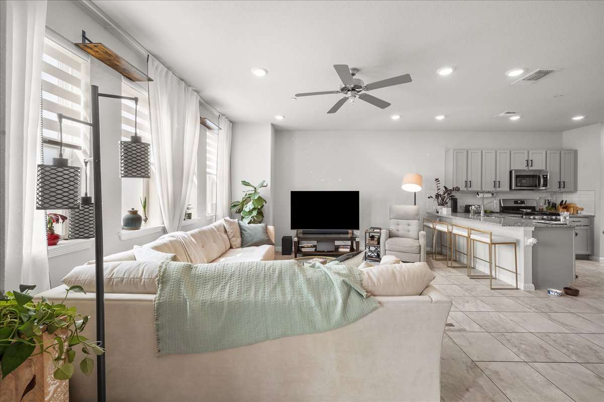 9015 Cattle Baron Path, Unit 1203 Austin, TX 78747 - Photo 9 of 23 Living room with ceiling fan and recessed lighting
