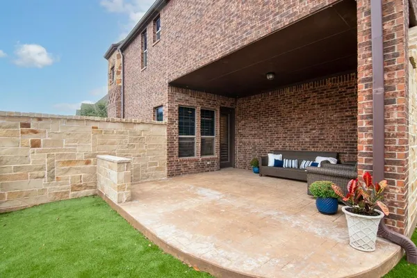 a view of a patio with table and chairs and potted plants