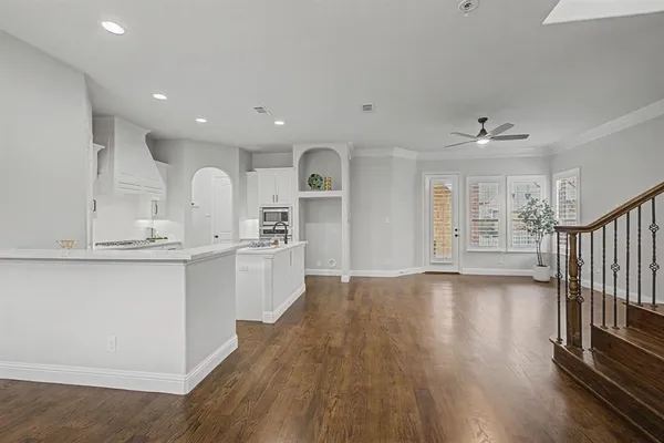 a view of a kitchen with wooden floor and window
