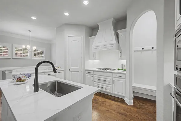 a kitchen with stainless steel appliances granite countertop a white stove top oven and sink