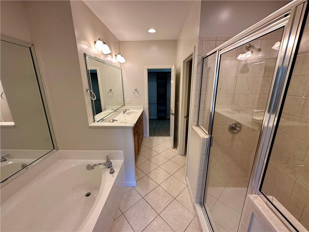 1615 Rivers Edge Trail Northeast Atlanta, GA 30324 - Photo 12 of 26 a bathroom with a sink a mirror and a bathtub