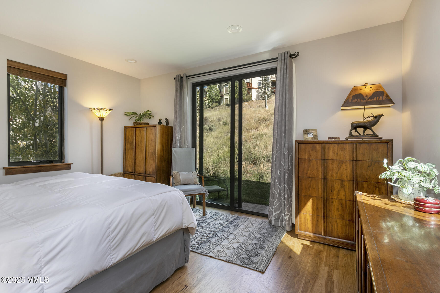 1015 West Wildwood Road, Unit H Avon, CO 81620 - Photo 15 of 38 a bedroom with a bed and wooden floor