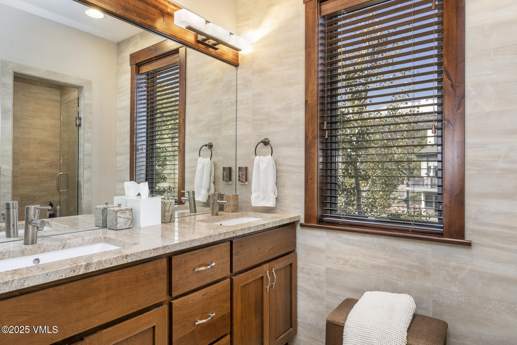 1015 West Wildwood Road, Unit H Avon, CO 81620 - Photo 17 of 38 a bathroom with a granite countertop sink and a mirror