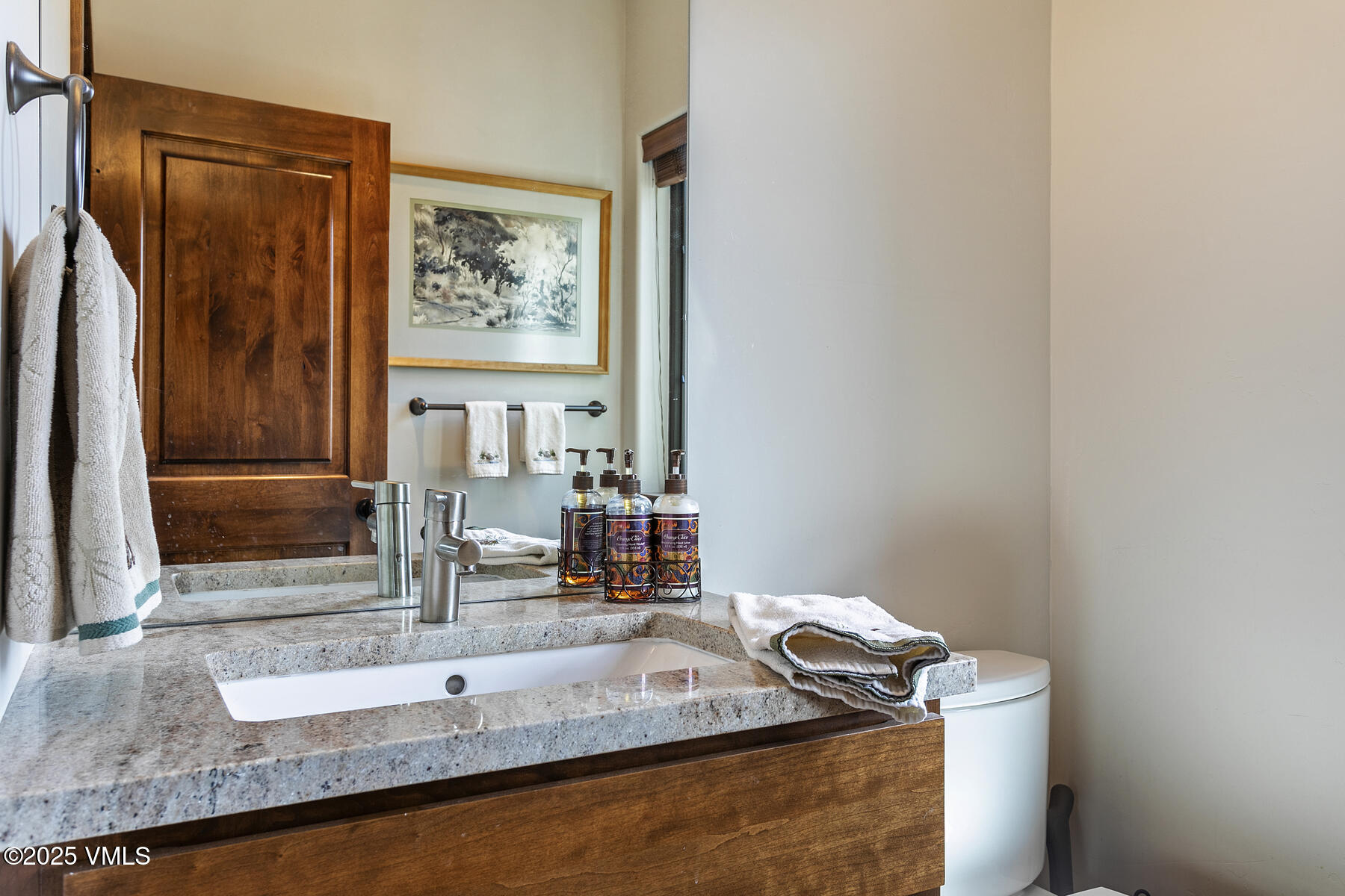 1015 West Wildwood Road, Unit H Avon, CO 81620 - Photo 18 of 38 a bathroom with a granite countertop sink and a mirror