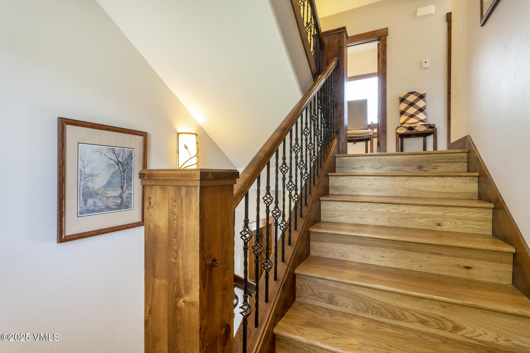 1015 West Wildwood Road, Unit H Avon, CO 81620 - Photo 20 of 38 a view of staircase with wooden floor and a chandelier