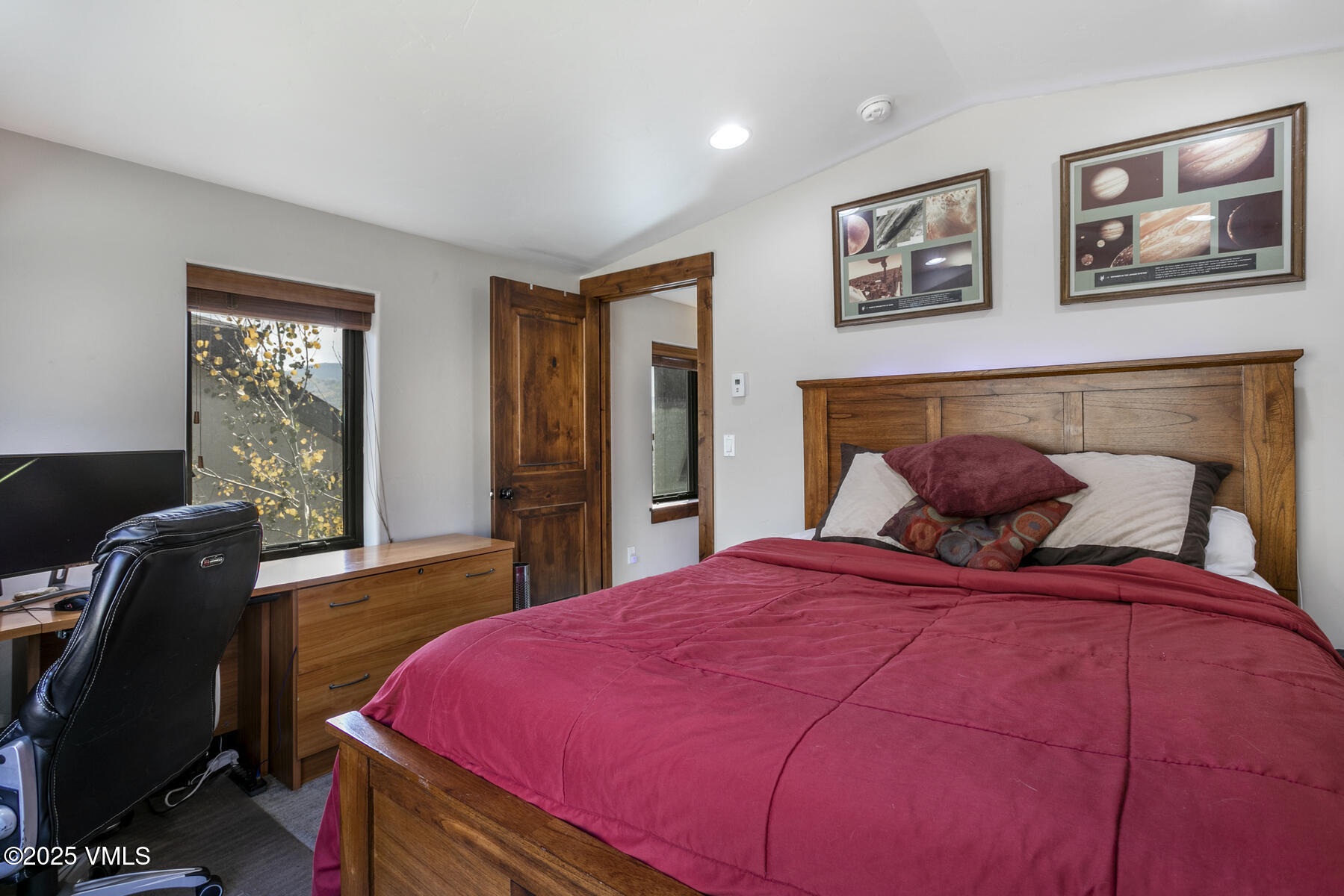 1015 West Wildwood Road, Unit H Avon, CO 81620 - Photo 25 of 38 a bedroom with a bed and wooden floor