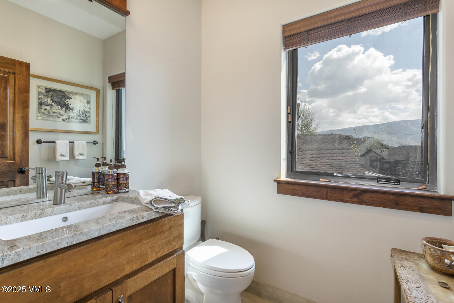1015 West Wildwood Road, Unit H Avon, CO 81620 - Photo 27 of 38 a bathroom with a granite countertop sink mirror vanity and toilet