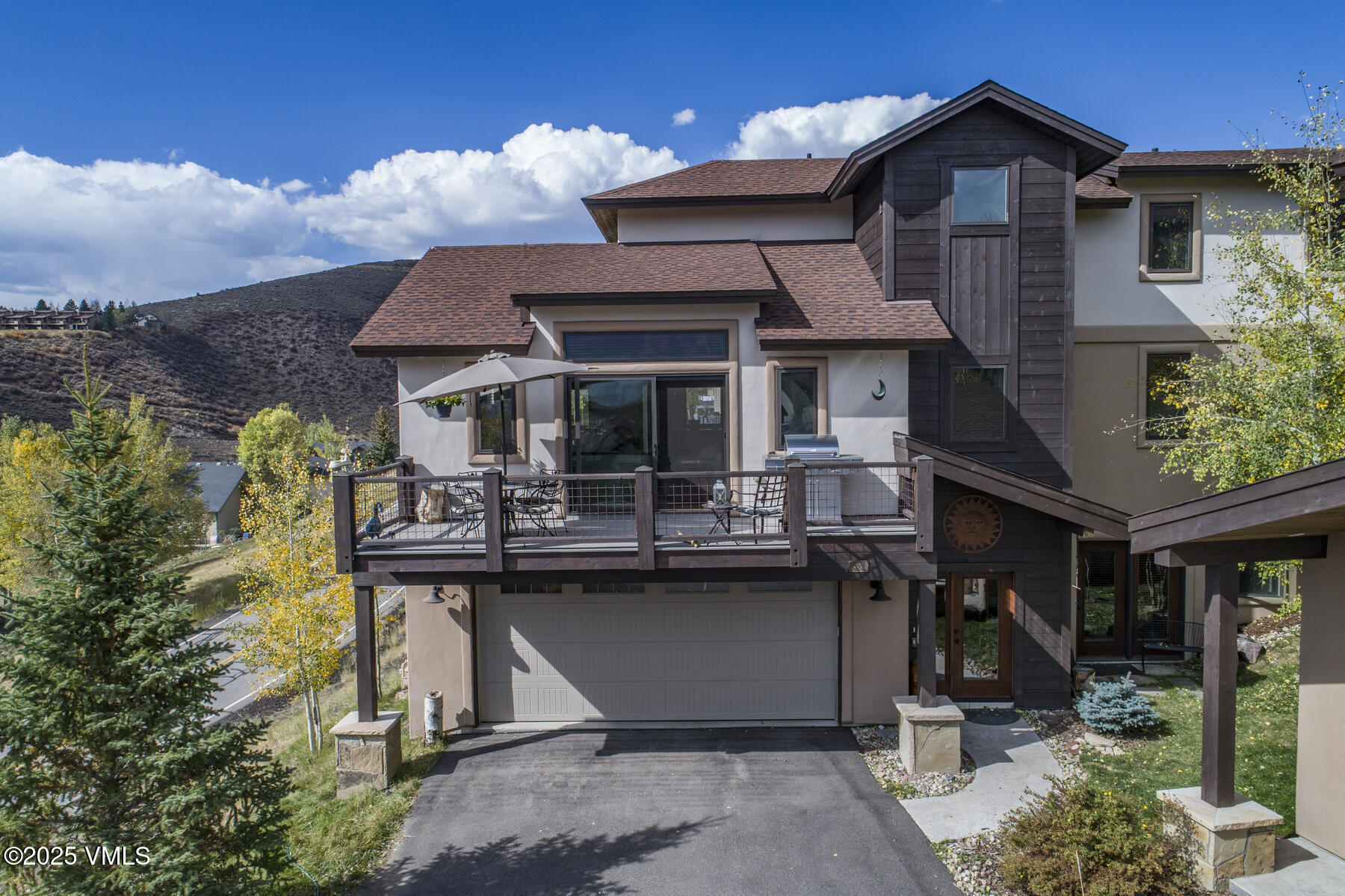 1015 West Wildwood Road, Unit H Avon, CO 81620 - Photo 38 of 38 a table and chairs in front of the house