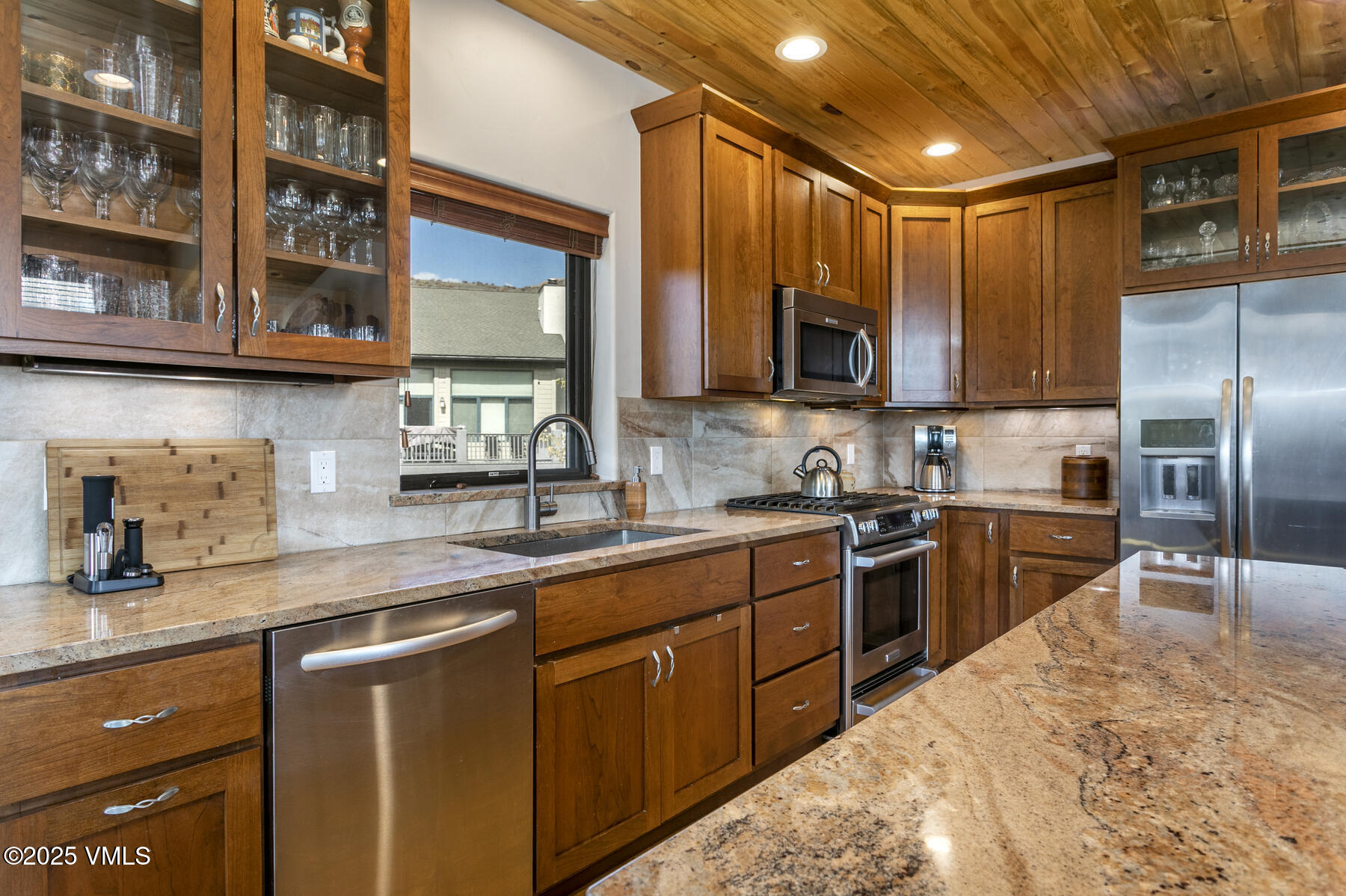 1015 West Wildwood Road, Unit H Avon, CO 81620 - Photo 4 of 38 a kitchen with stainless steel appliances granite countertop a sink a stove and cabinets