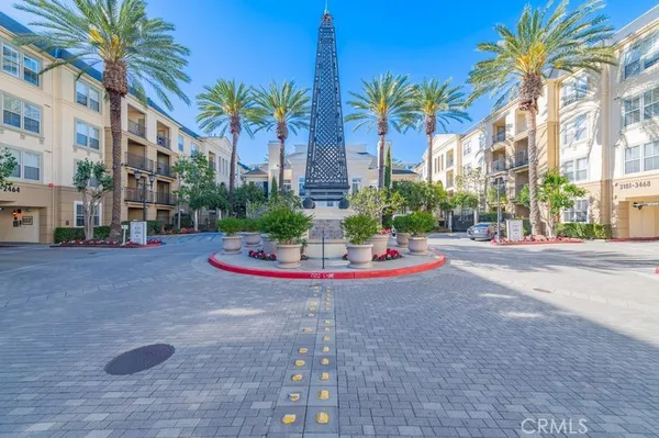 a view of a building with a yard and palm trees