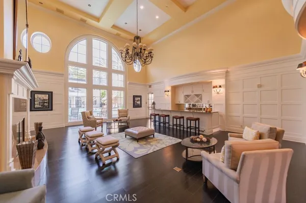 a living room with furniture chandelier and a large window