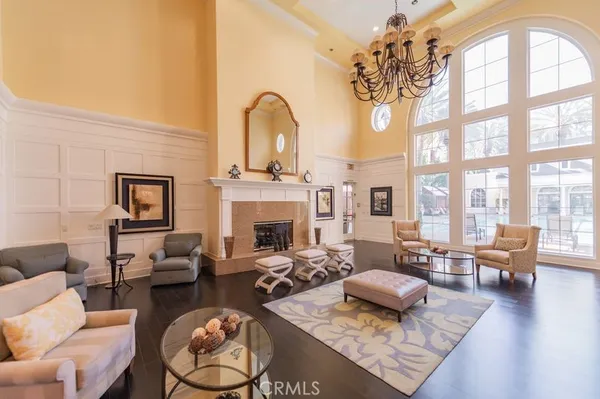 a living room with furniture a fireplace and large windows