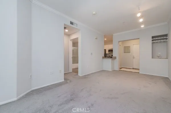 an empty room with closet and mirrors