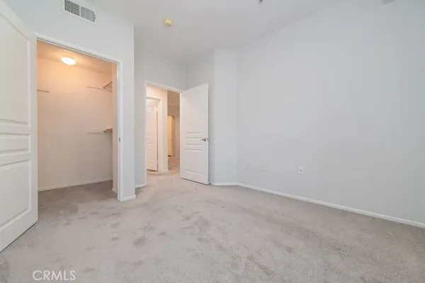 an empty room with closet area